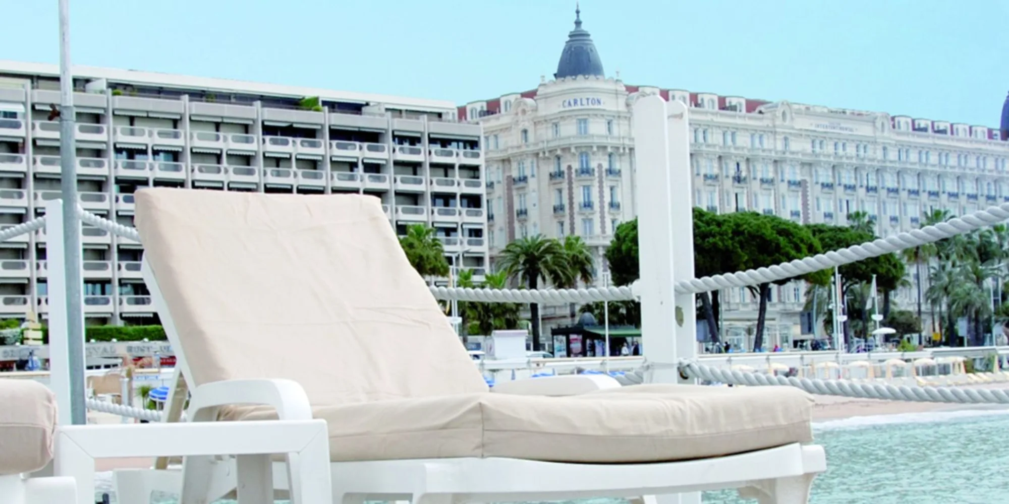 Annex Beach - white sunbeds hotel backdrop