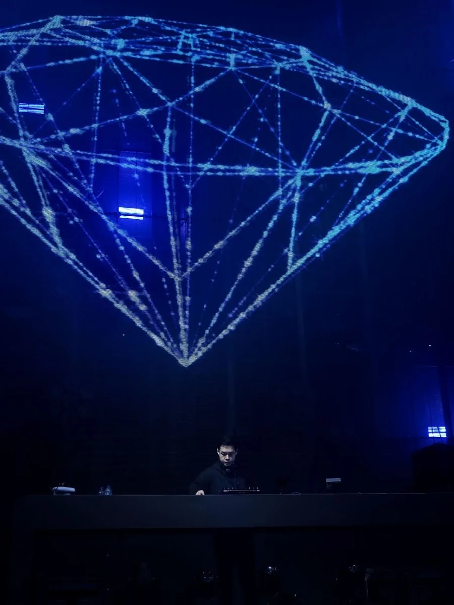 Atlas Superclub - fix signature kinetic chandelier lit as a blue wireframe diamond over the dj booth iconic atlas feature
