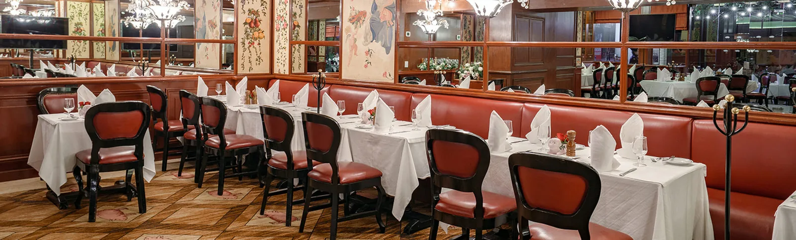 Au Pied de Cochon - dining room banquettes and mirrors