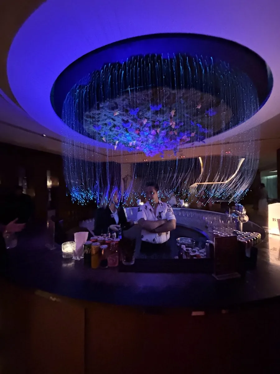 Baccarat Bangkok - fix signature blue fiber optic beaded circular chandelier over the lounge hero feature