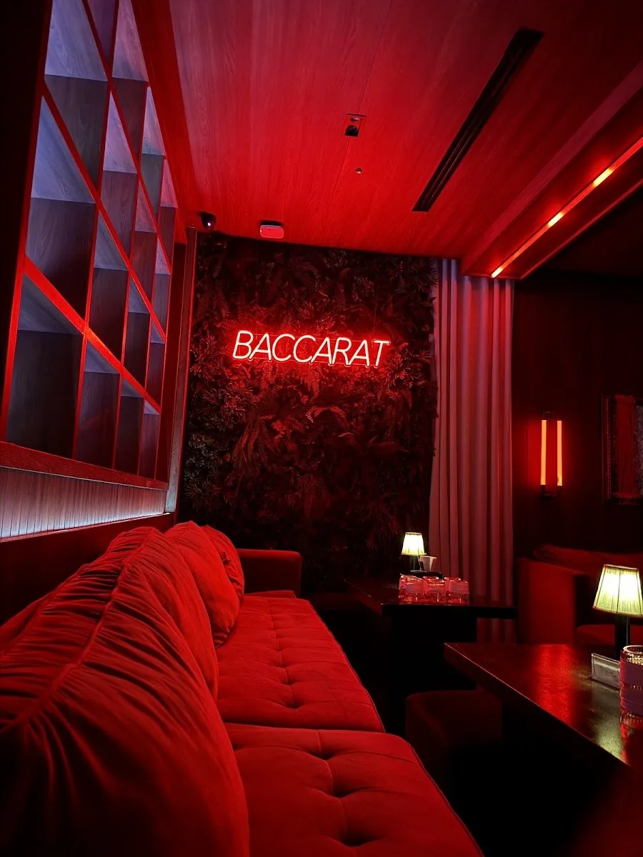 Baccarat Bangkok - fix red velvet banquette under baccarat red neon on a botanical wall moody on brand no crowd