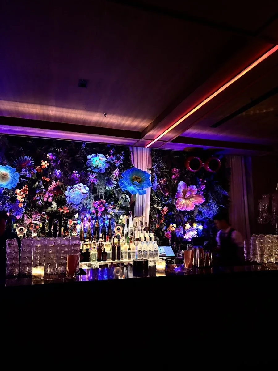 Baccarat Bangkok - fix bar backed by a vivid multicolour floral botanical wall purple ambient distinctive