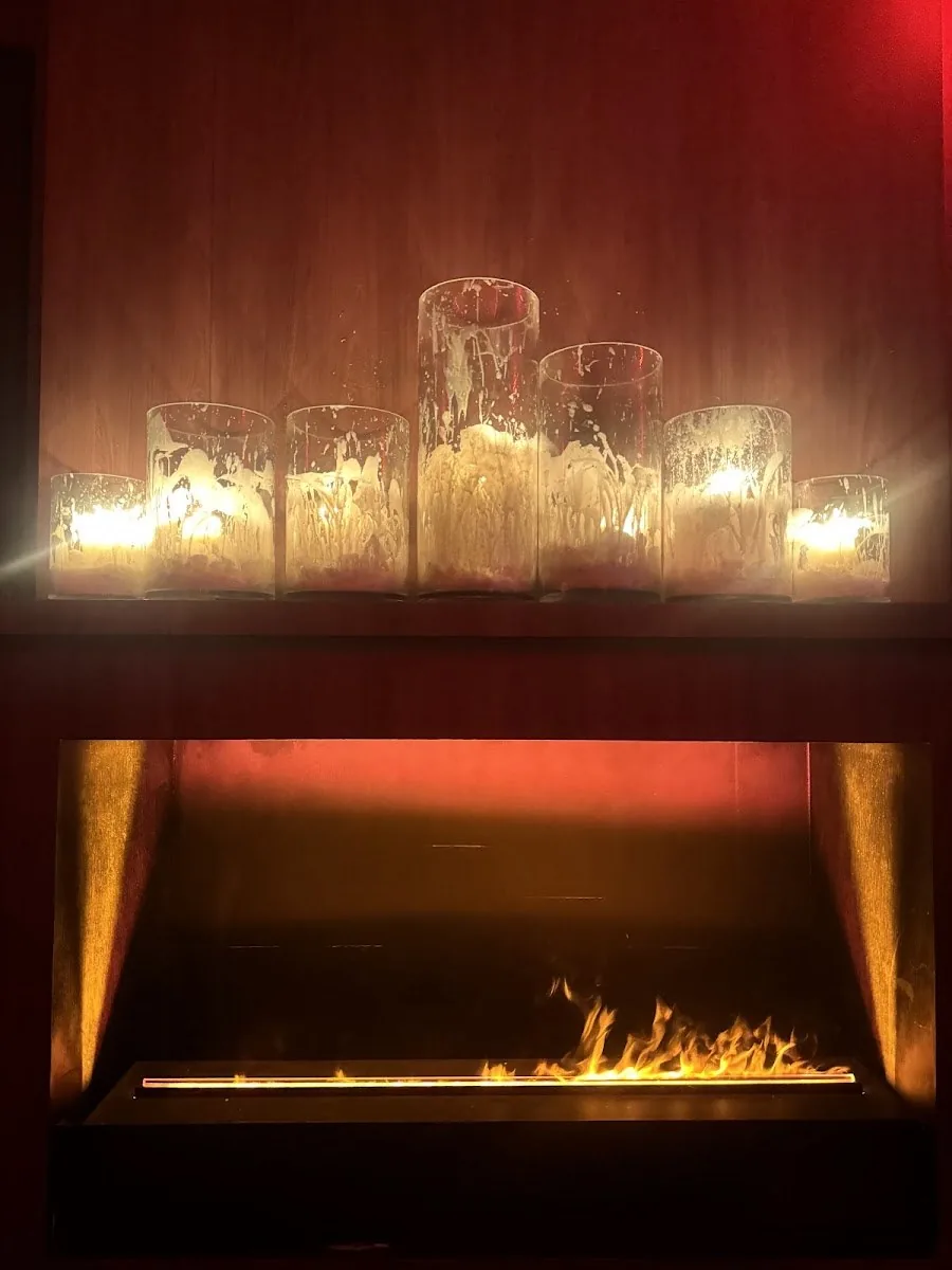 Baccarat Bangkok - fix candle cluster above a linear fireplace fire feature cozy signature detail