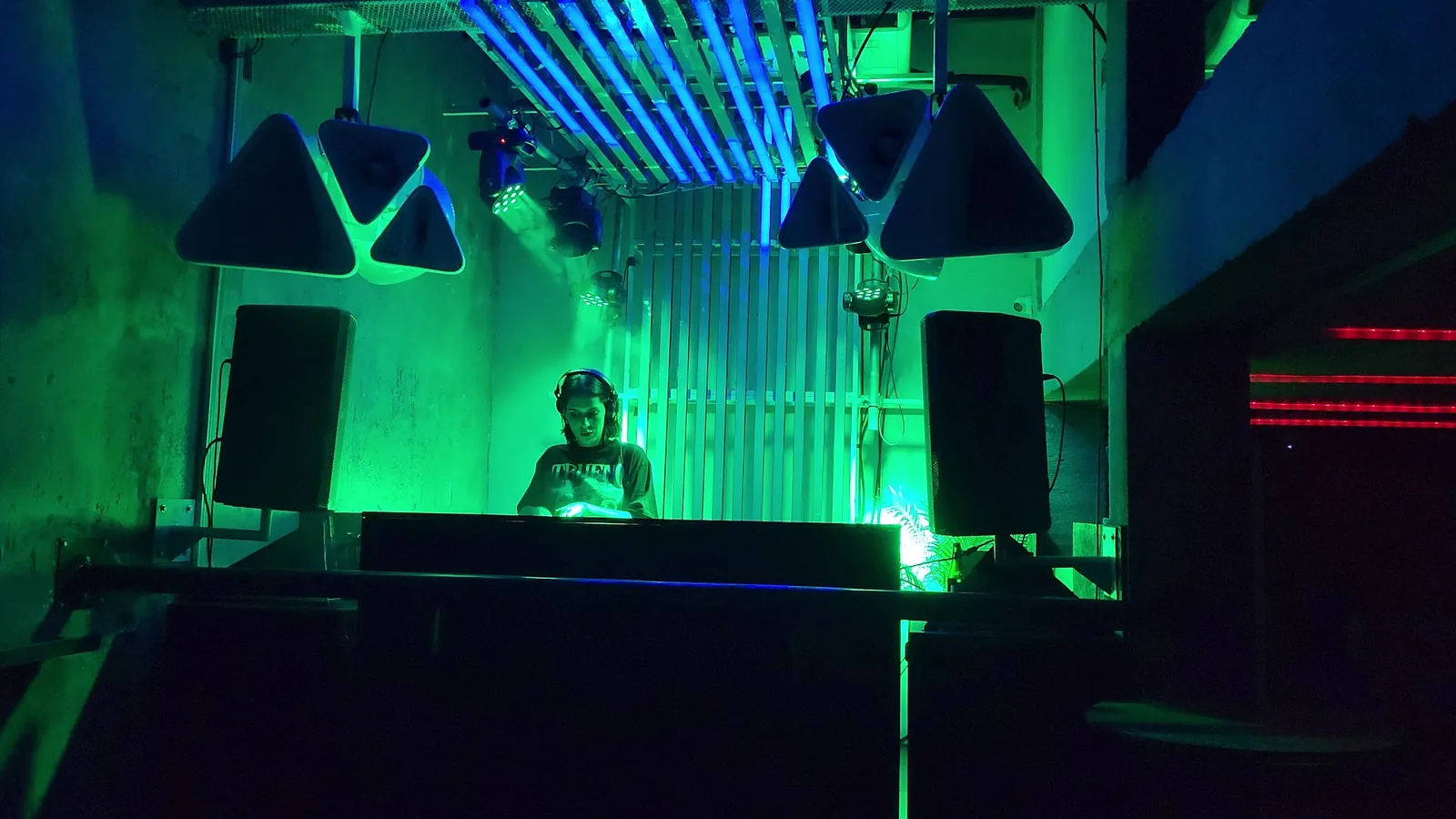 Bar Oriente - dj booth under green lighting
