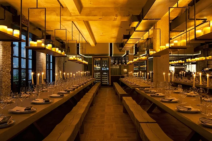 Beast - communal tables candlelit aisle