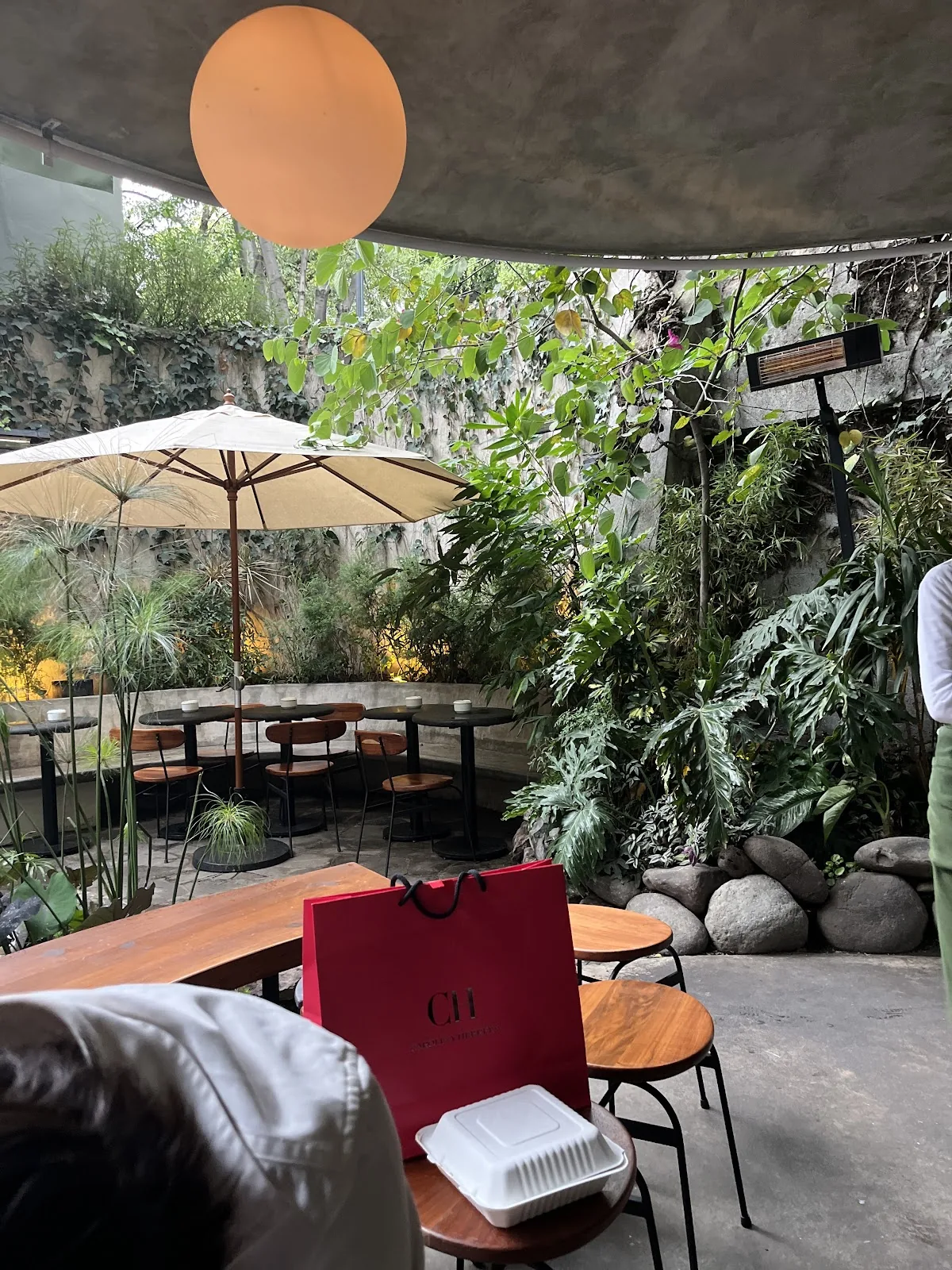 Botanico - terrace tables under a parasol