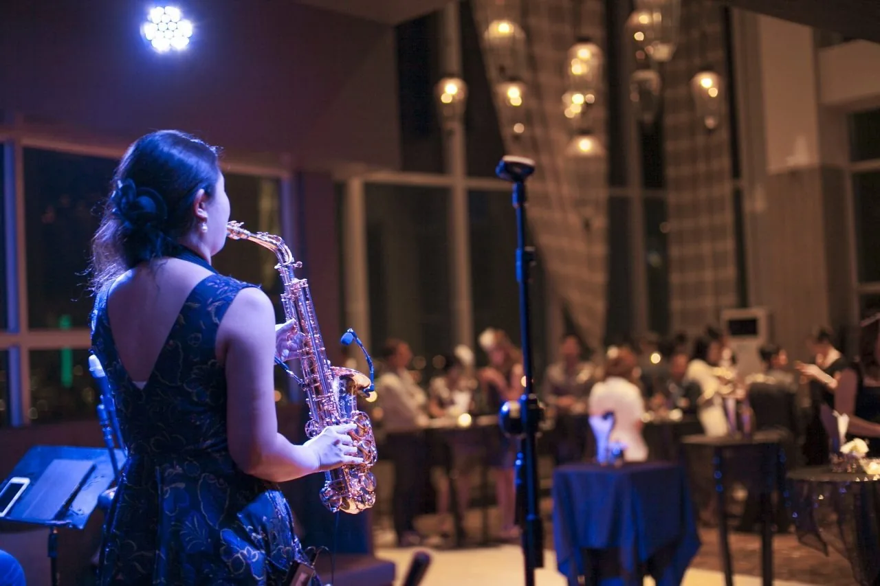 Cielo Sky Bar - saxophonist performing over the evening rooftop crowd