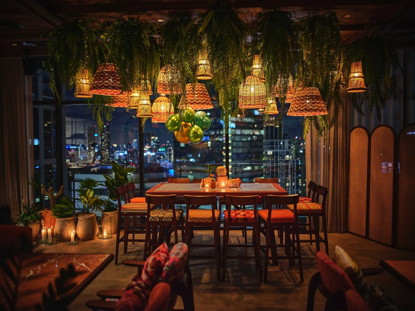 Cielo Sky Bar - fix greenery draped rooftop dining nook lanterns skyline night