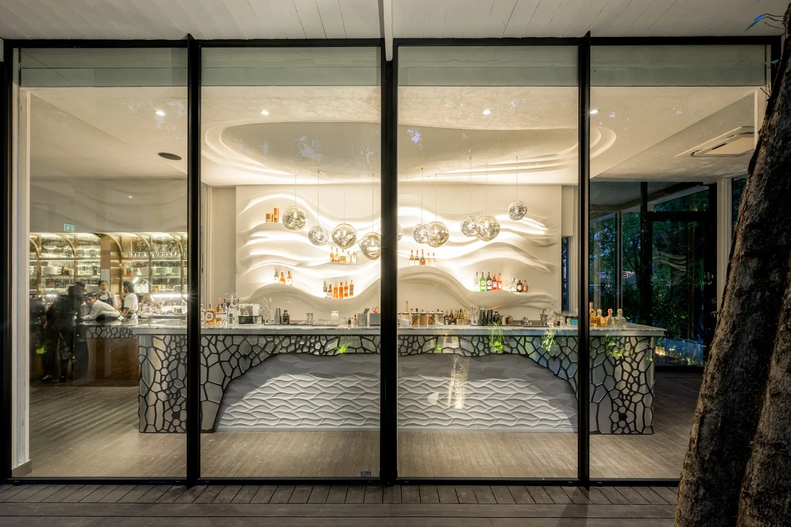 Coda - interior open kitchen chef counter behind glass landscape