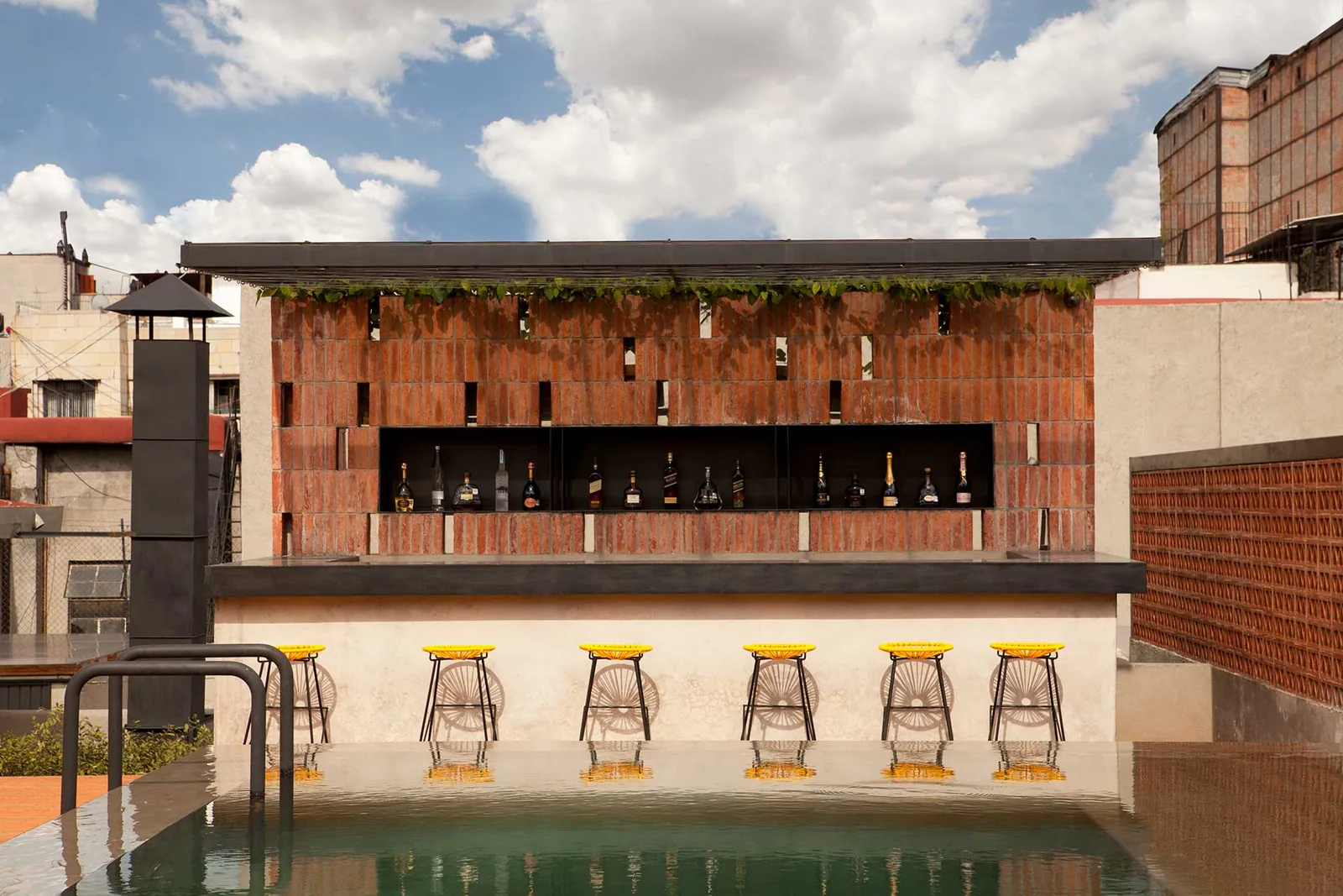 Terraza Downtown - brick poolside bar with yellow bar stool