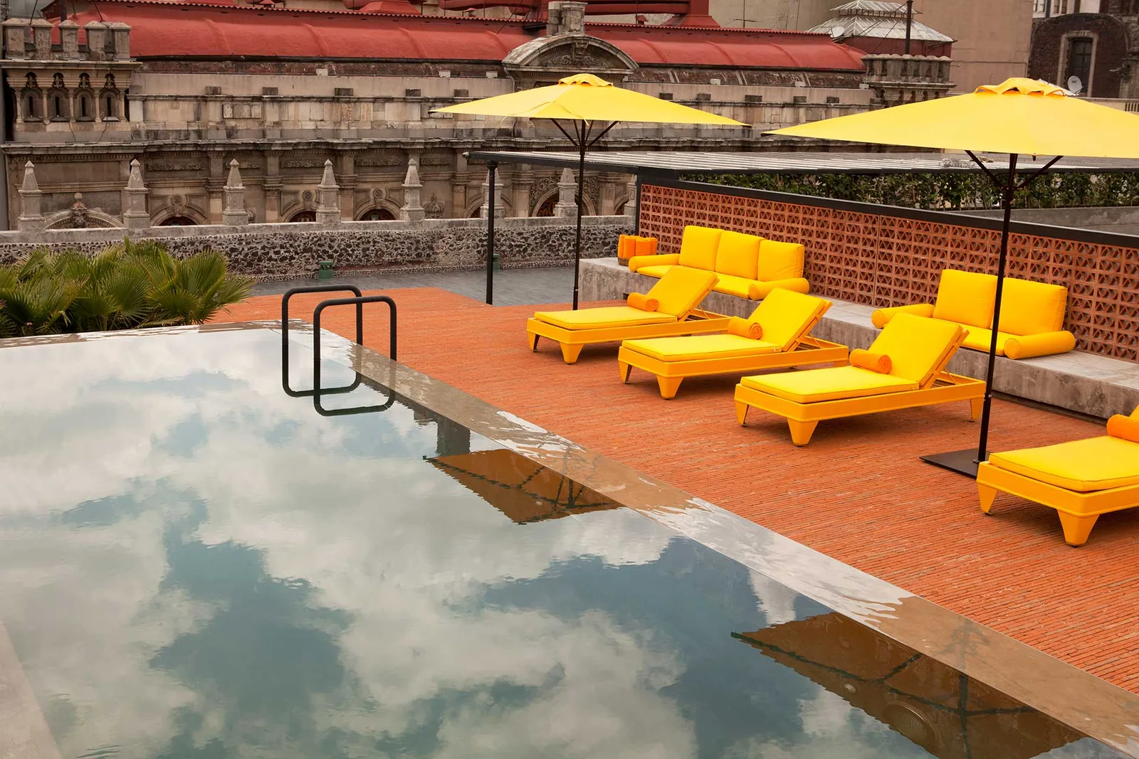 Terraza Downtown - rooftop pool with yellow sun loungers on