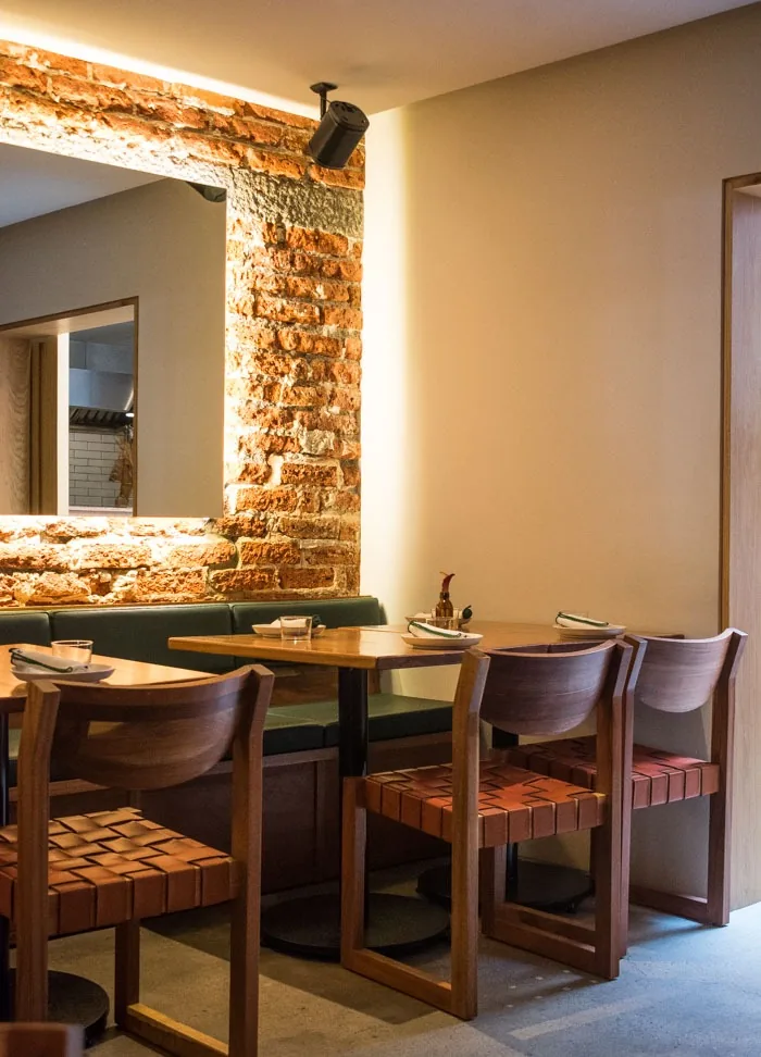 Gaba - dining room with exposed brick green ba