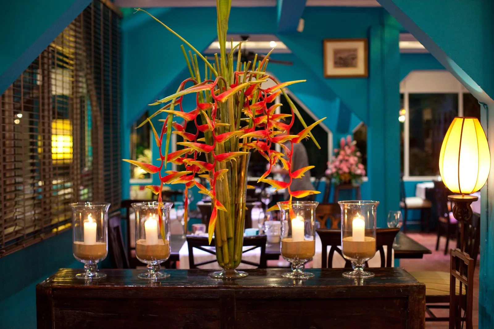 Issaya Siamese Club - teal salon with a towering tropical flower arrangement and candlelight interior non food
