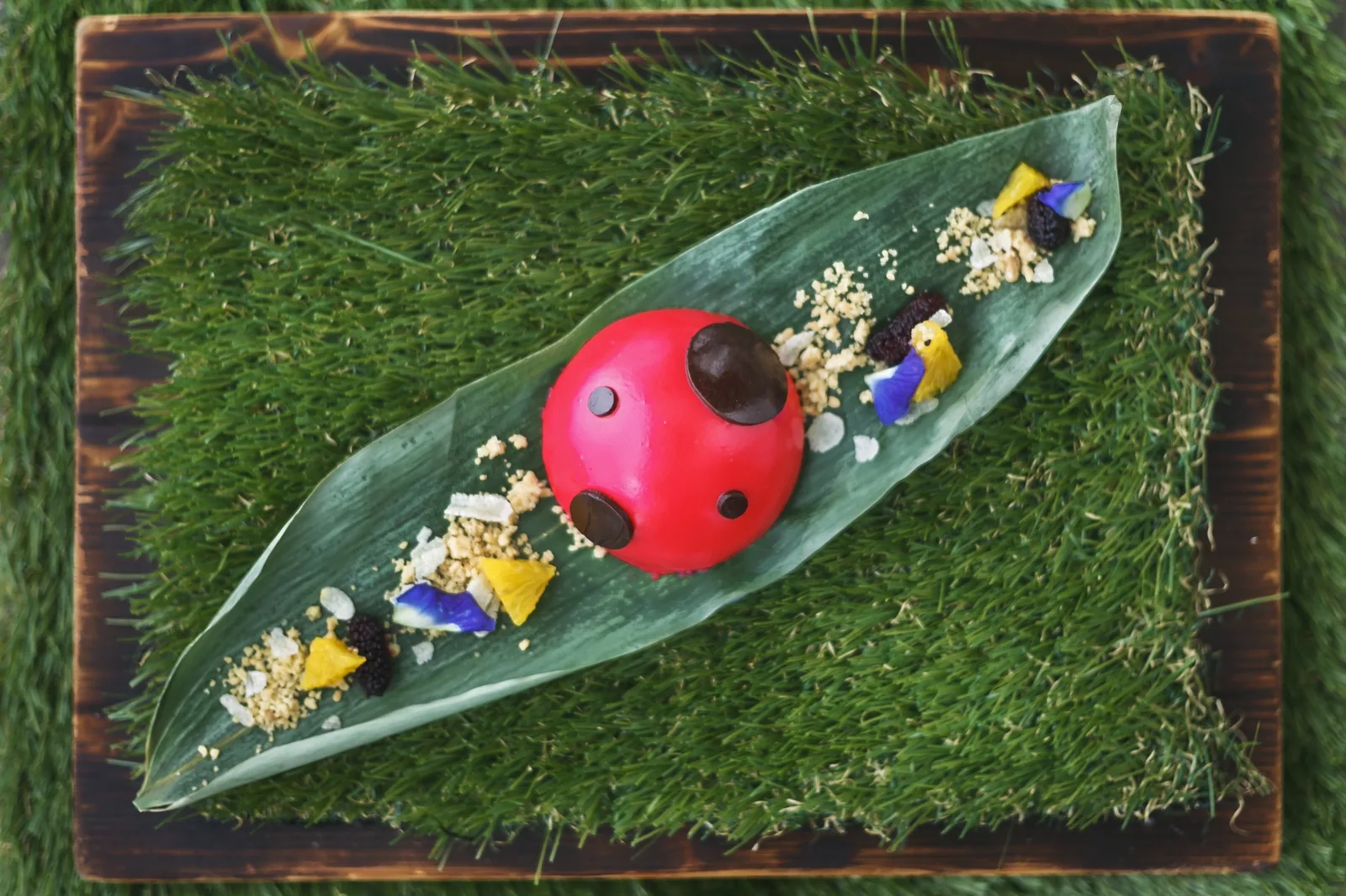 Issaya Siamese Club - whimsical ladybird form signature canape on a fresh grass mat food