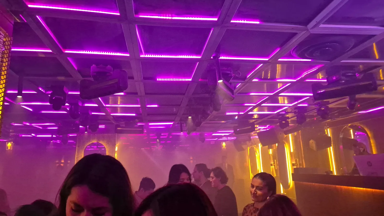 Kennedy Social Room - room under purple lighting with guests