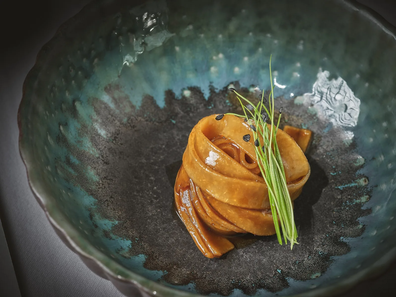 KHAAN - elegant plated course in a teal stoneware bowl food