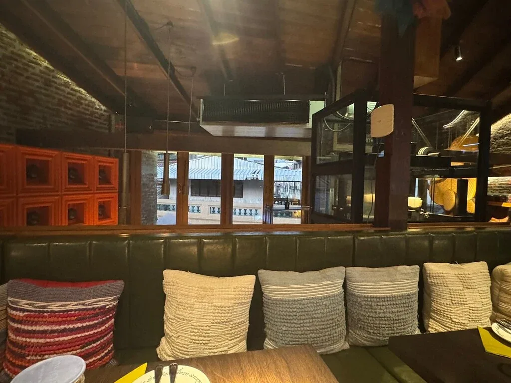 Khao San Sek - add upstairs green banquette room red windows rooftop view