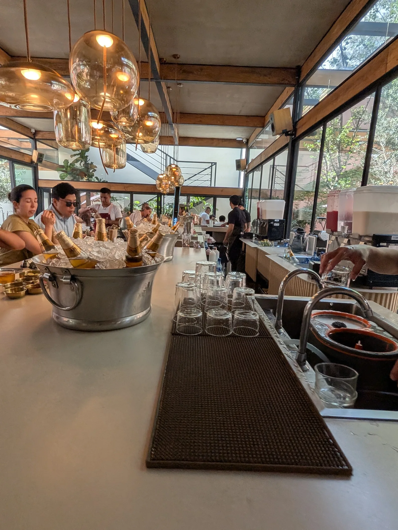 La Once Mil - bar service counter with brass pendants