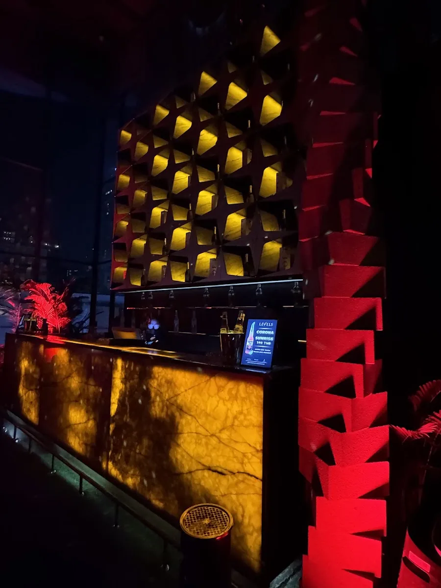 Levels Club & Lounge - add signature gold pyramid textured feature wall bathed in dramatic red lighting