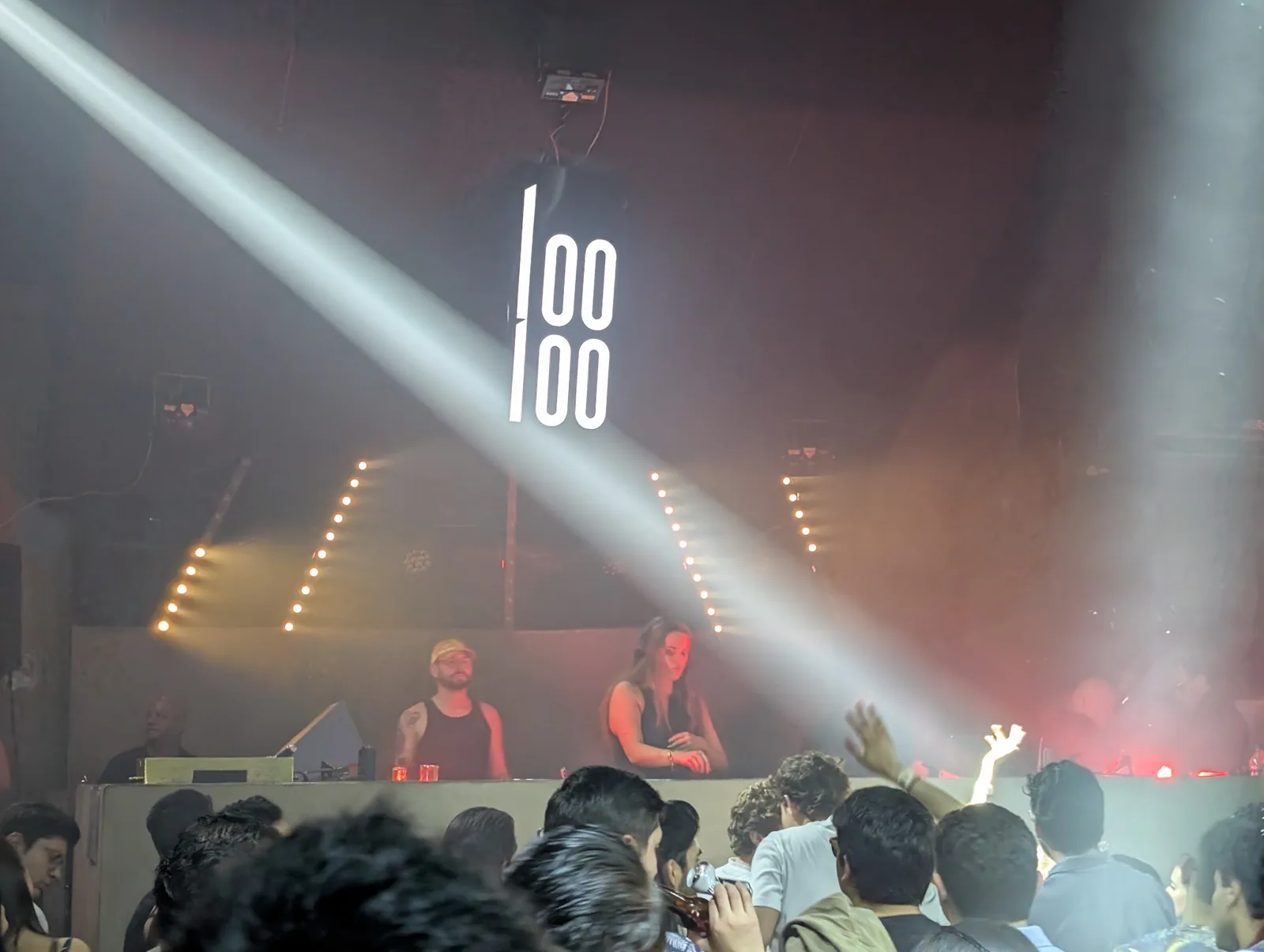 Looloo Studio - dj booth and crowd under beam lights
