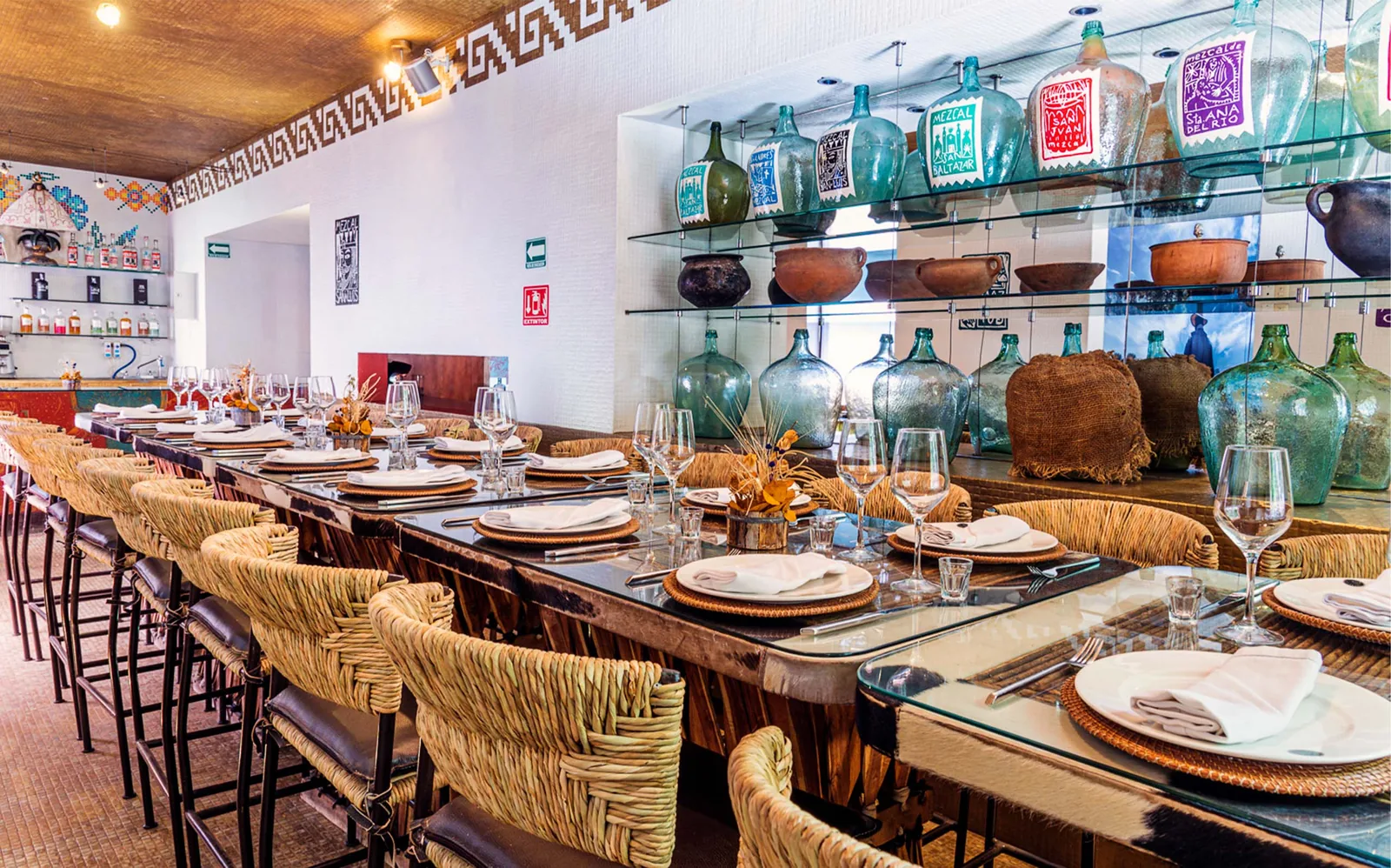 Los Danzantes Coyoacan - bar with mezcal demijohns
