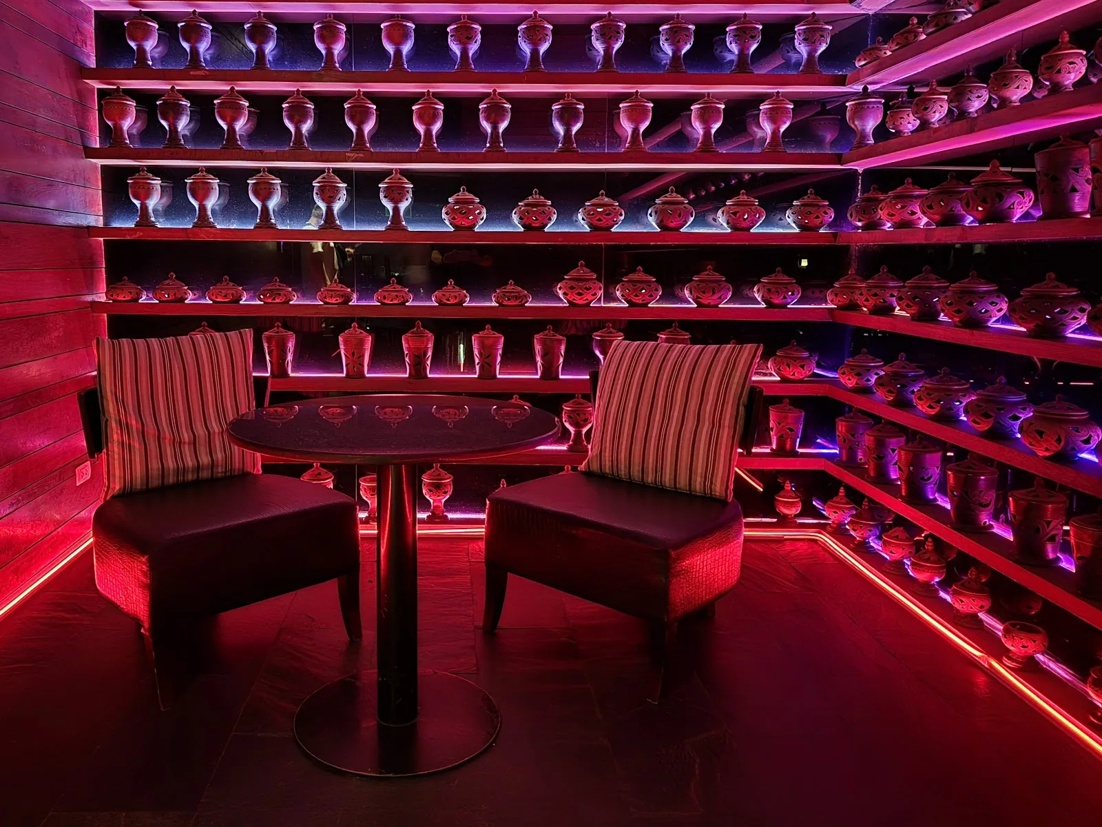 Octave Rooftop Lounge - add red purple lit indoor lounge with private booth seating and backlit bottle display wall
