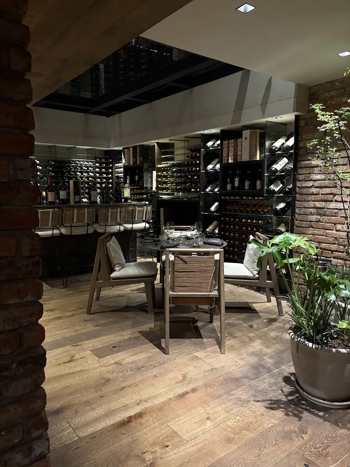 Osteria del Becco - dining room with wine racks and greenery