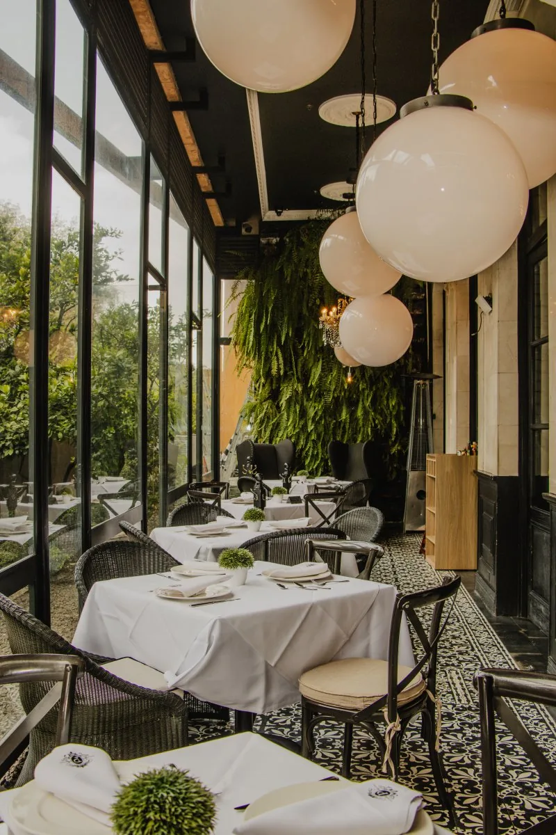 Prendes Moliere - window side dining under globe lights