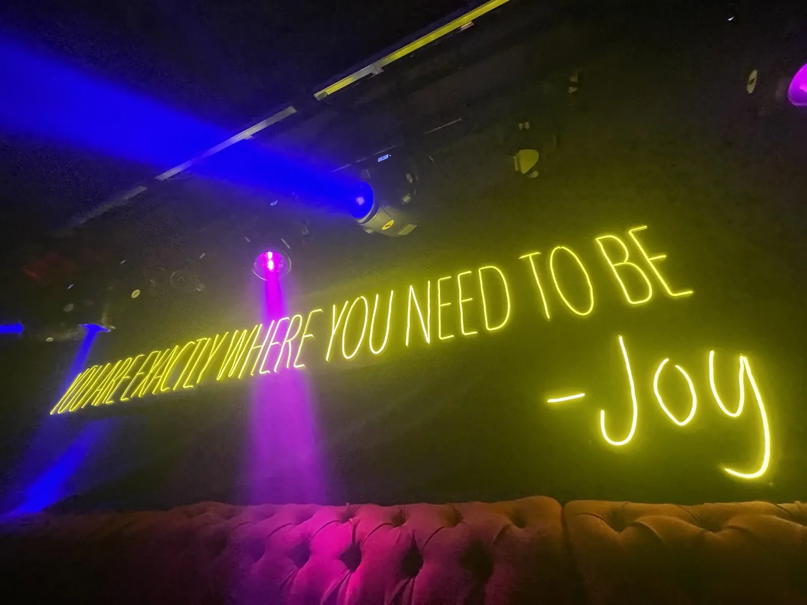Ragga Club by Joy - the venue s joy neon sign above a banque