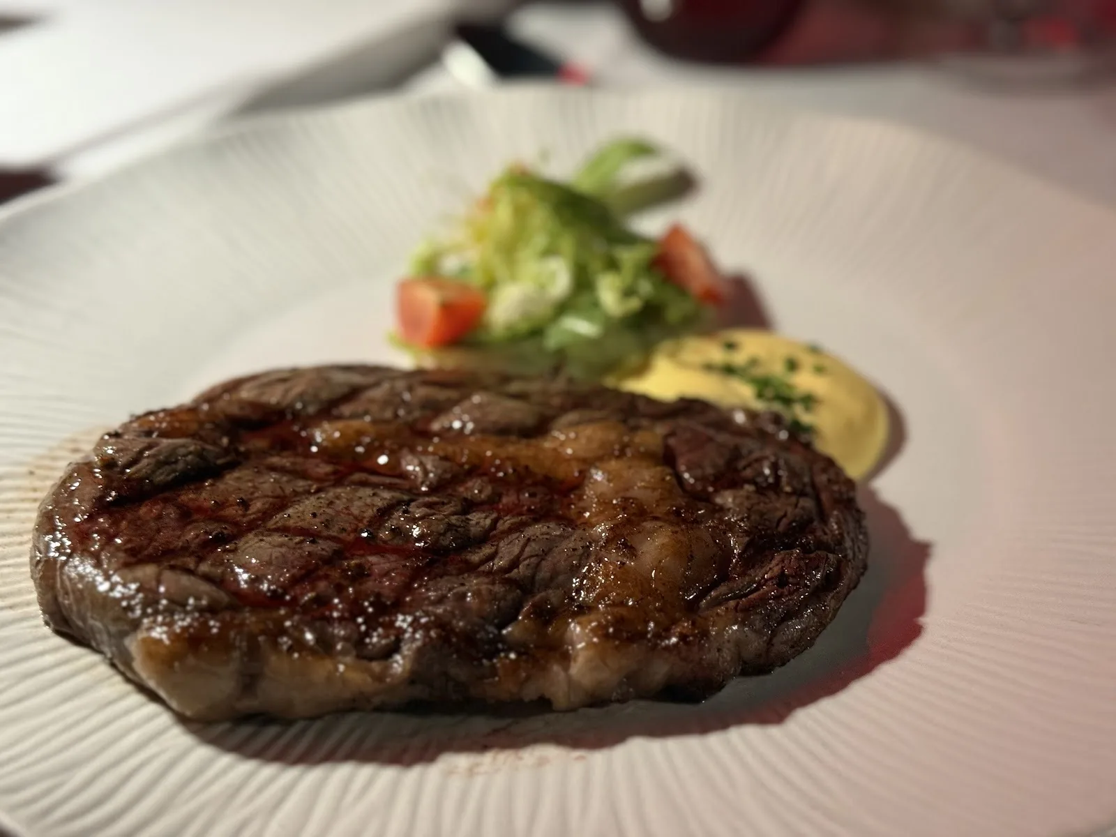 Red Sky (+ CRU Champagne Bar) - fix red sky grilled steak plated with garnis