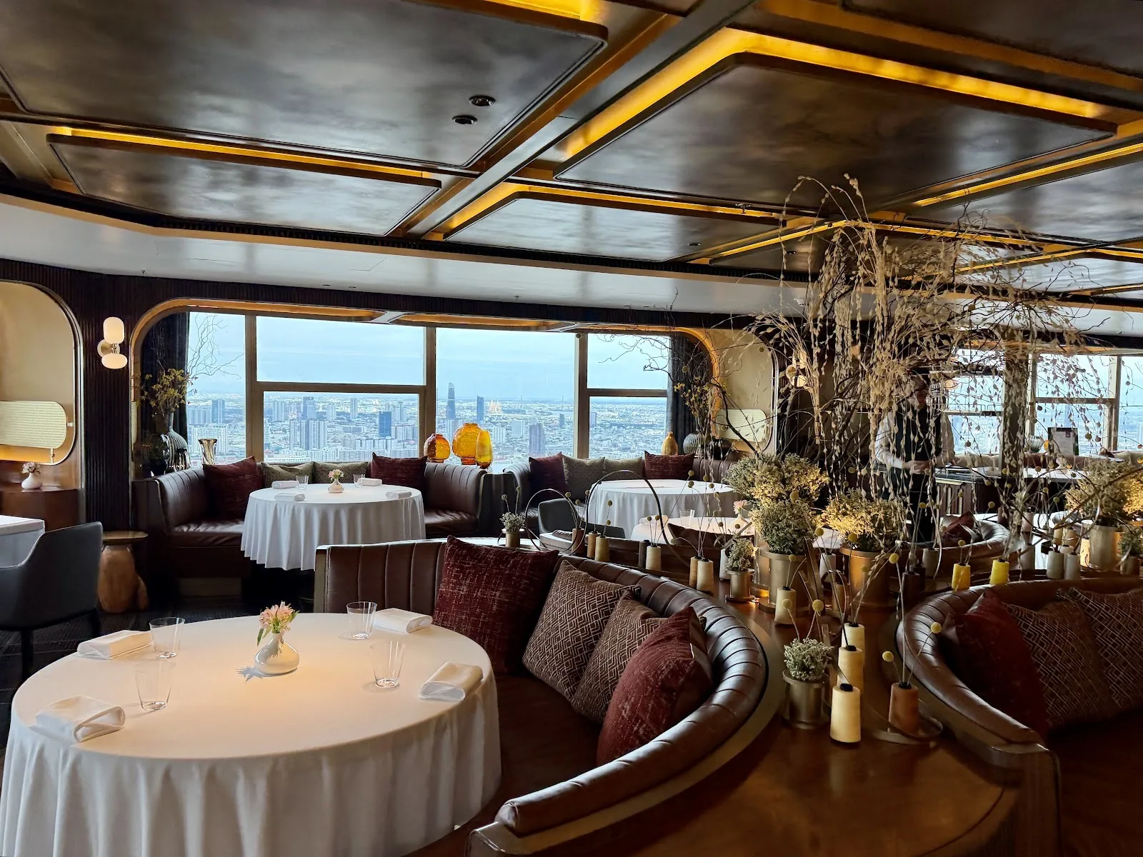 Sartoria by Paulo Airaudo - second dining room view with sculptural tree centerpiece and skyline windows