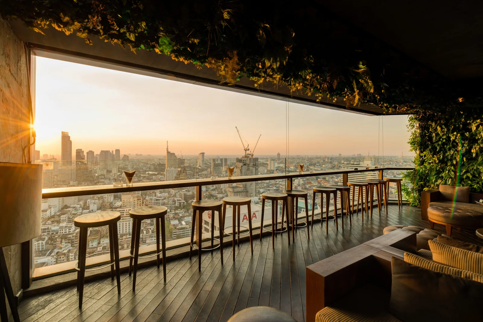 Scarlett - rooftop bar counter at golden hour with skyline