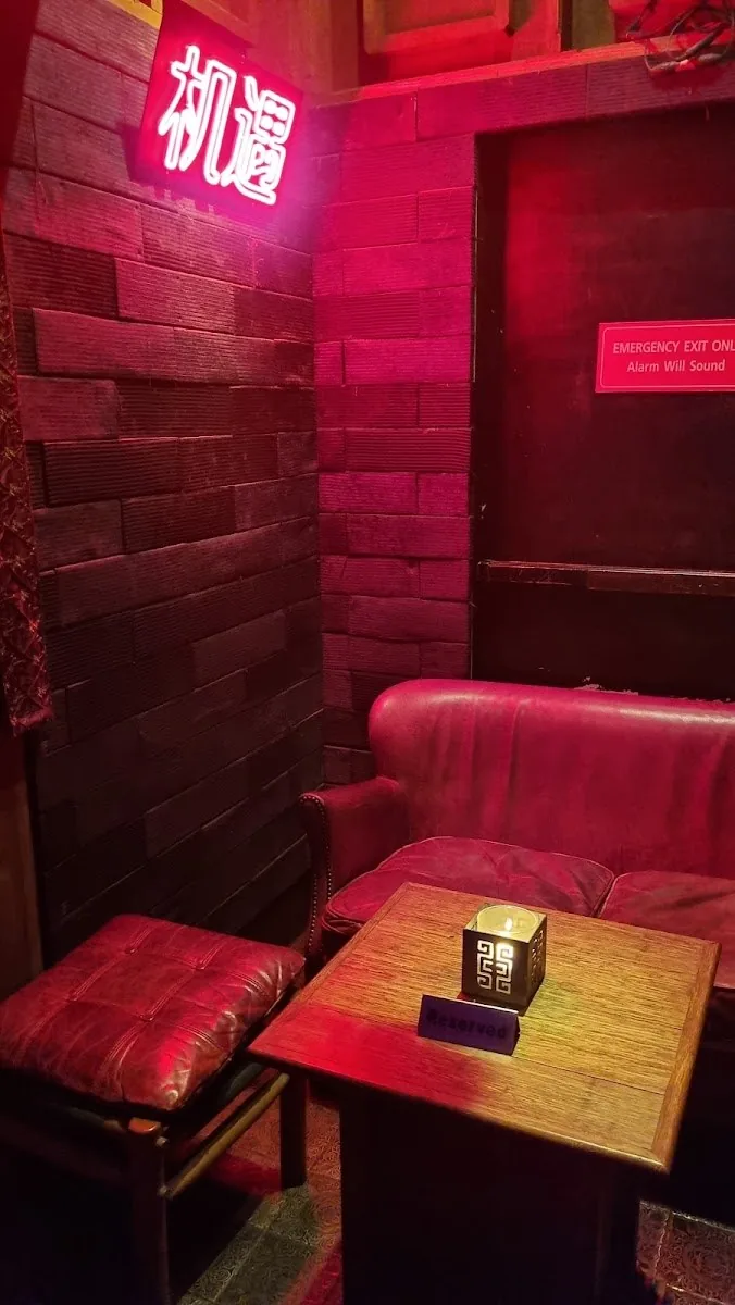 Sing Sing Theater - fix intimate red vip booth nook leather banquettes carved brick wall red neon chinese sign new angle