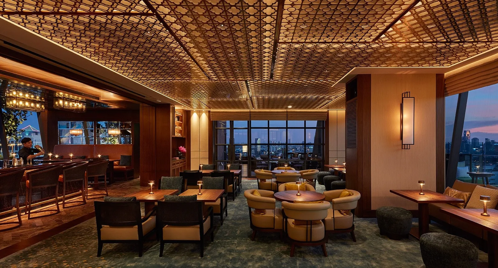 Spectrum Lounge - fix spectrum indoor lounge coffered gold ceiling armchairs and low tables floor to ceiling city view windows warm evening light