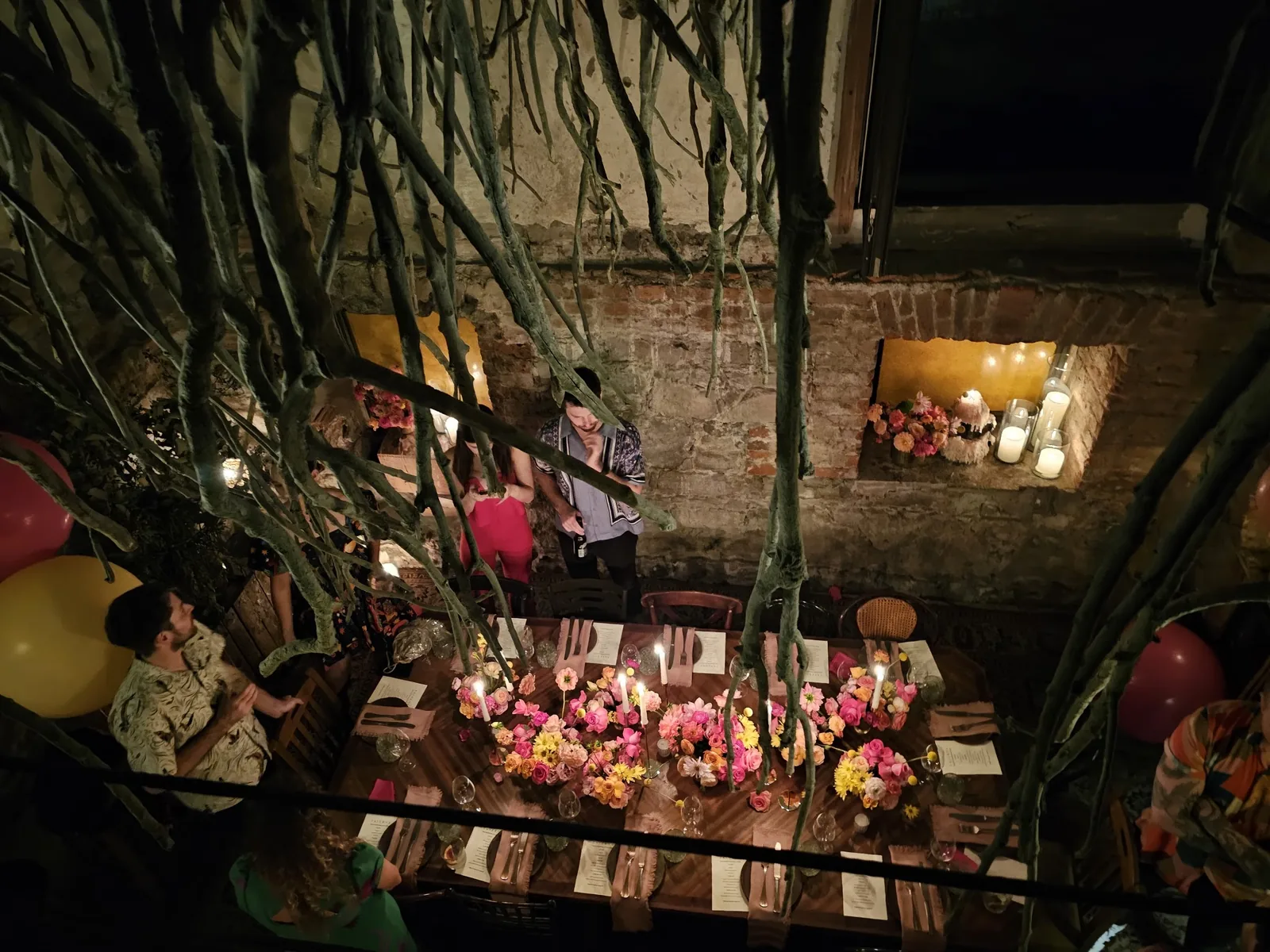 Taverna - long communal table dressed with flowers