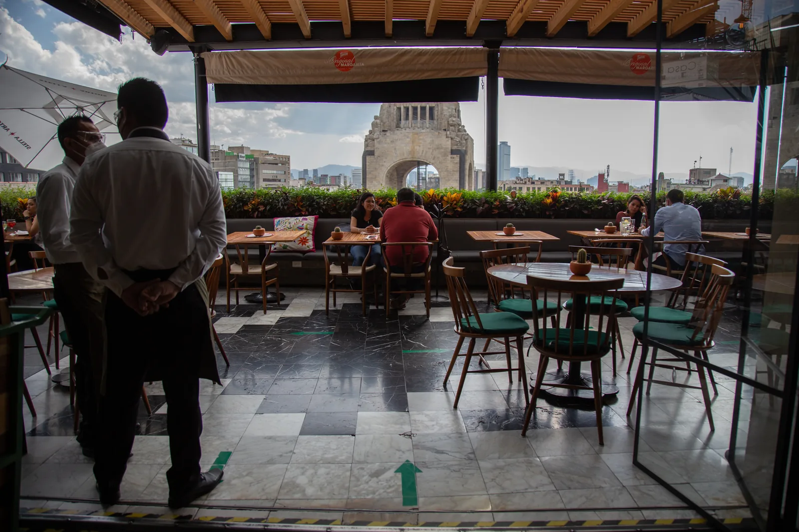 Terraza Cha Cha Cha - guests at terrace tables with the monume