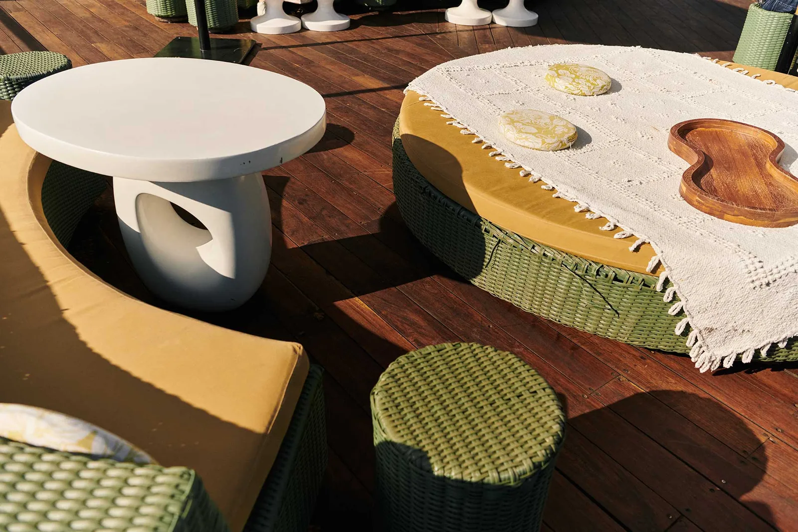 Terraza Condesa DF - sculptural white table beside a yellow d