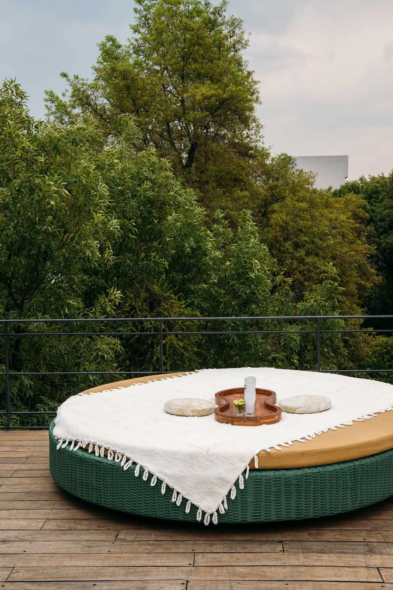 Terraza Condesa DF - circular green daybed on the deck facing