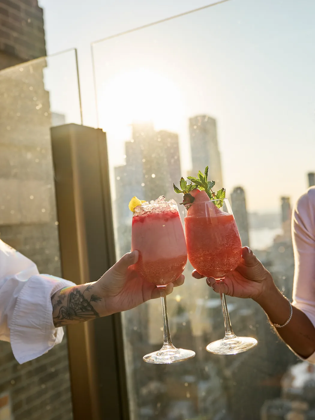 The Skylark - signature cocktails toast over skyline