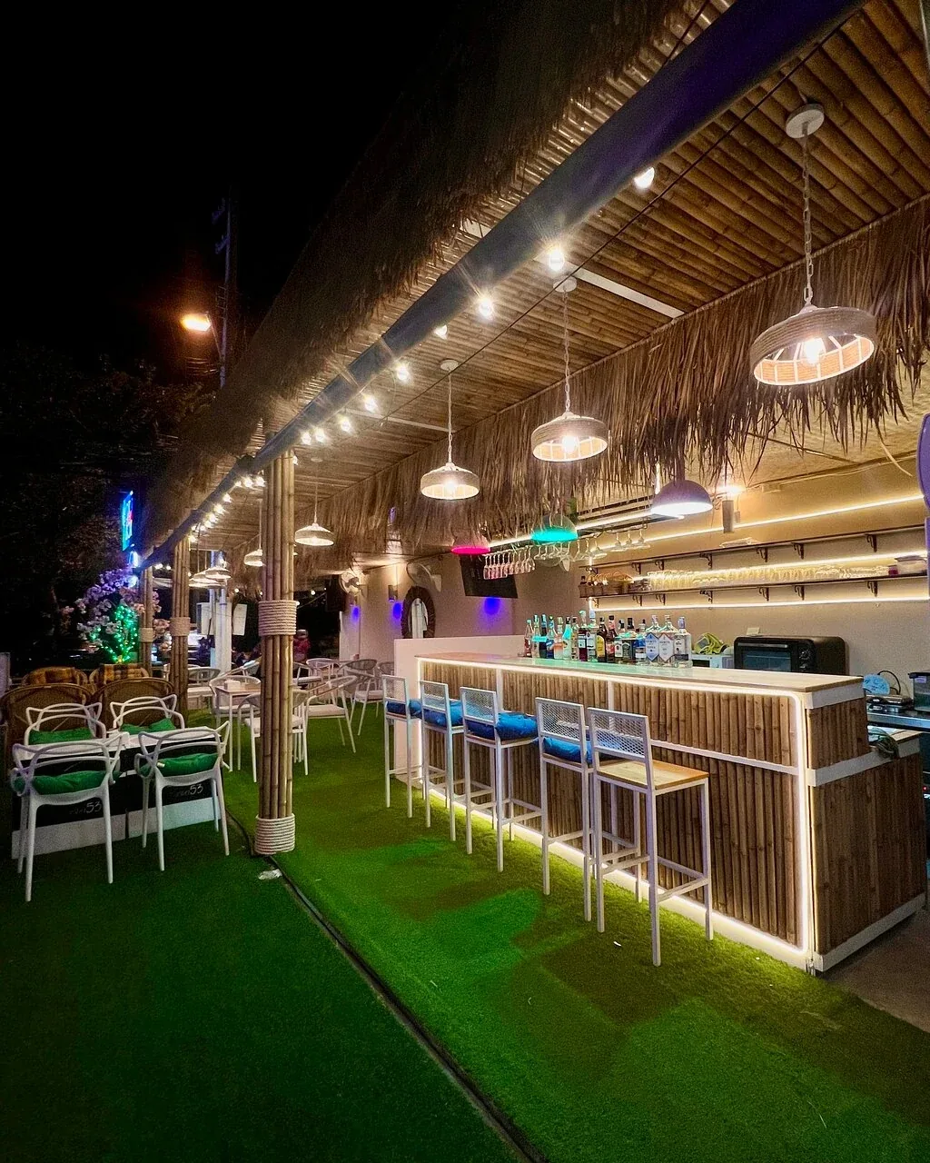 Tichuca Rooftop Bar - add night bar deck grass pendant lights