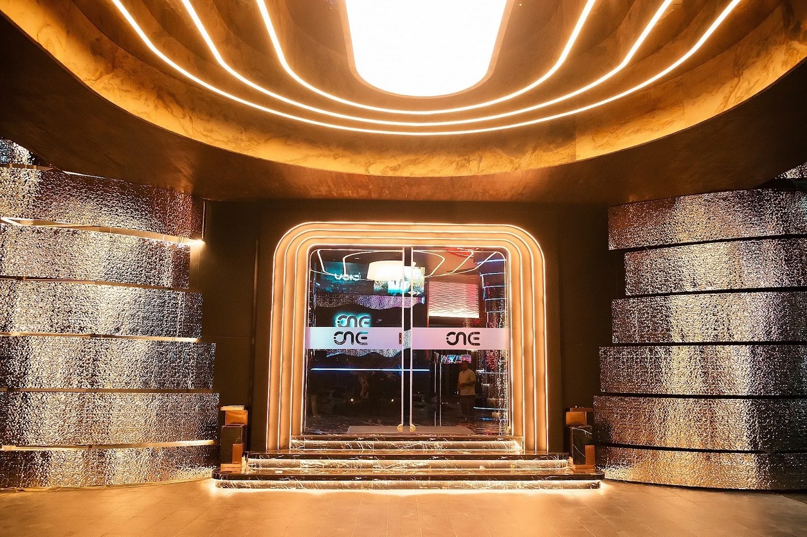 VOID Club - fix warm lit ribbed curved entrance lobby lounge clean interior