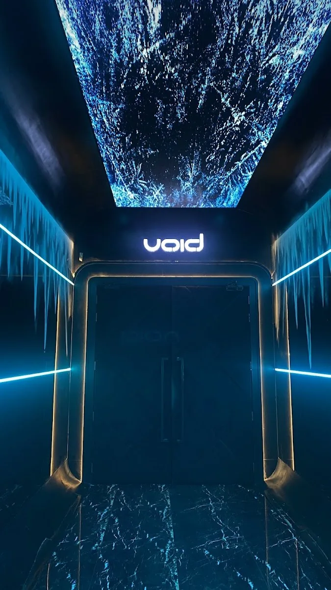 VOID Club - fix blue illuminated void portal doorway w shattered glass led ceiling neon floor lines signature entrance