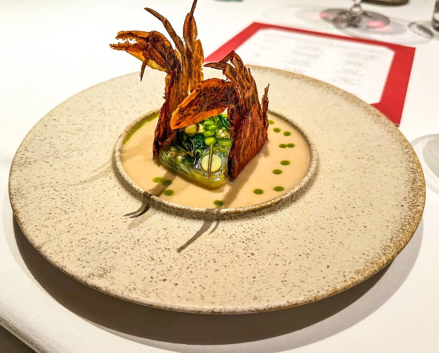 Wana Yook - plated fish course with crispy garnish