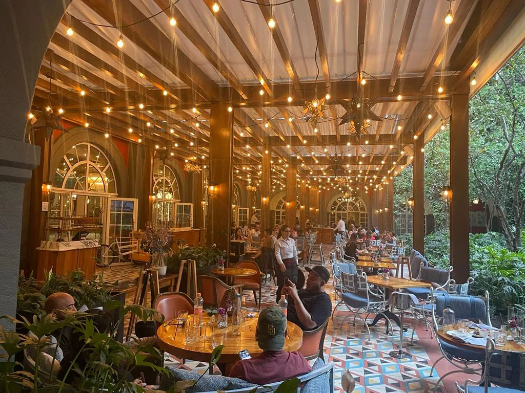 Zanaya - interior pergola string lights evening